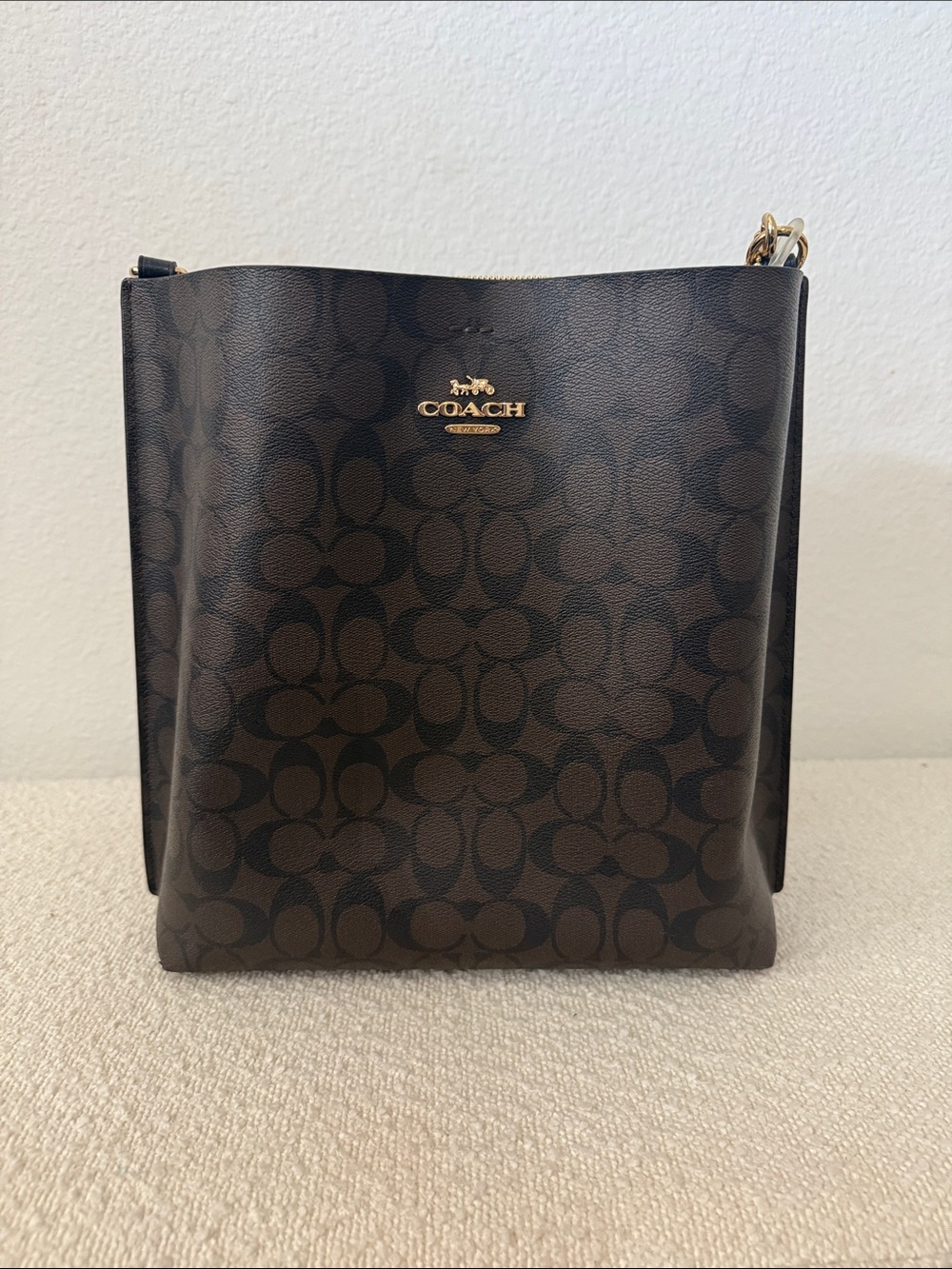 Coach woman’s Dark Brown Signature Messenger Bag with Gold Hardware